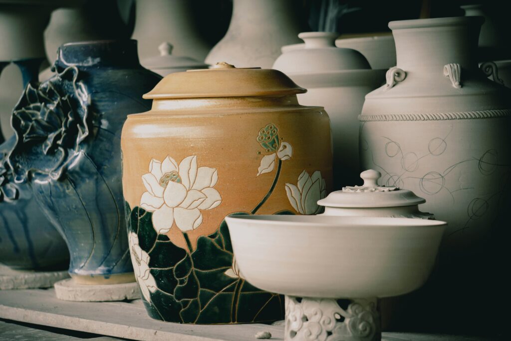 A collection of elegant handcrafted ceramic vases featuring detailed floral designs.